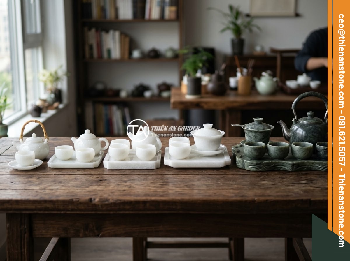 Top 5 sai lầm phổ biến khi chọn mua bộ ấm chén bằng đá cần tránh - Various sizes and styles of natural stone tea sets arranged in a row on a dark w