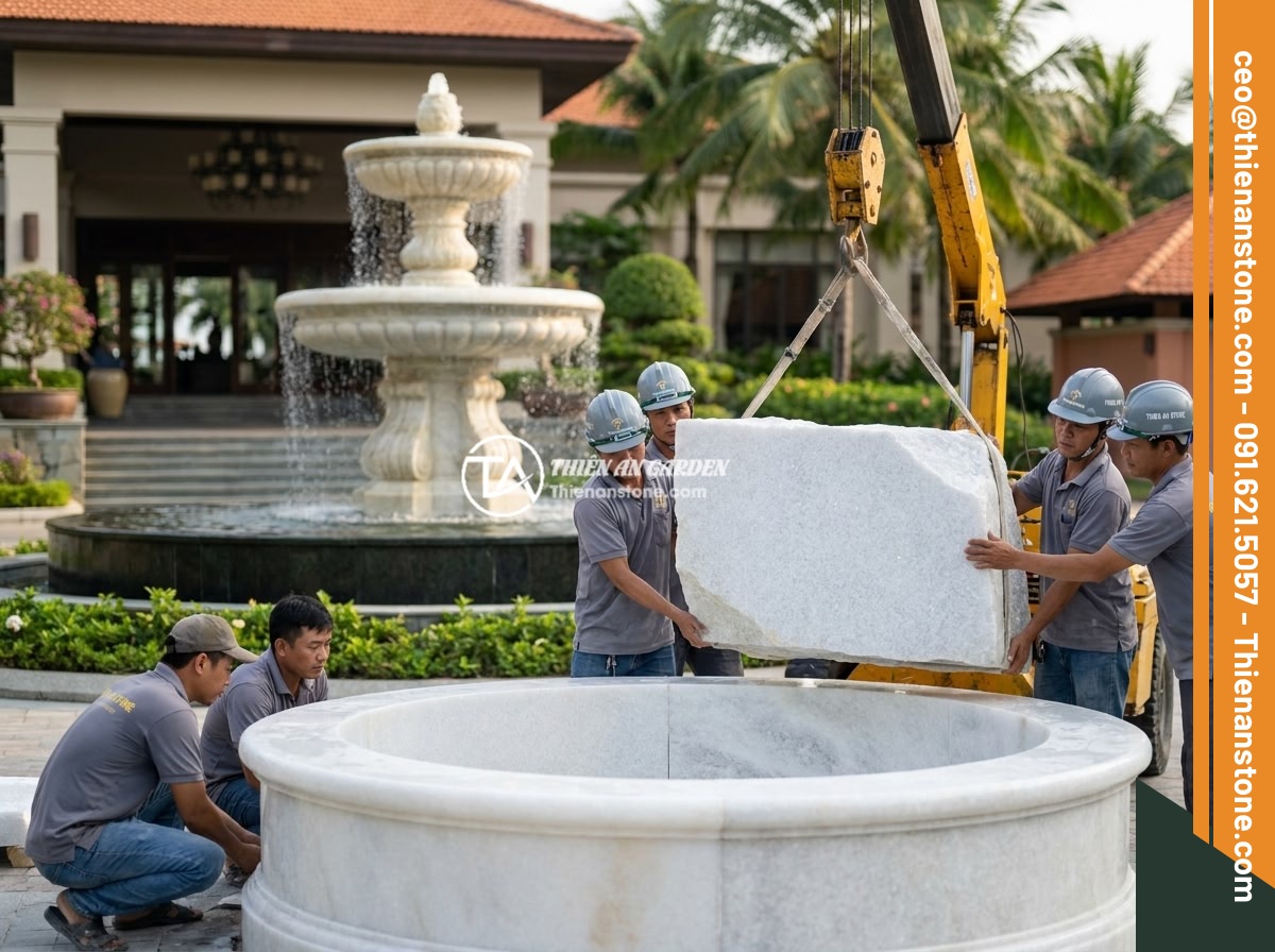 Đài Phun Nước Bằng Đá Là Gì? Cấu Tạo, Nguyên Lý Hoạt Động Và Lợi Ích Phong Thủy - Hình 12 Đài Phun Nước Bằng Đá Là Gì? Cấu Tạo, Nguyên Lý Hoạt Động Và Lợi Ích Phong Thủy - Professional team of Thien An Stone company installing a large multi-tiered ston