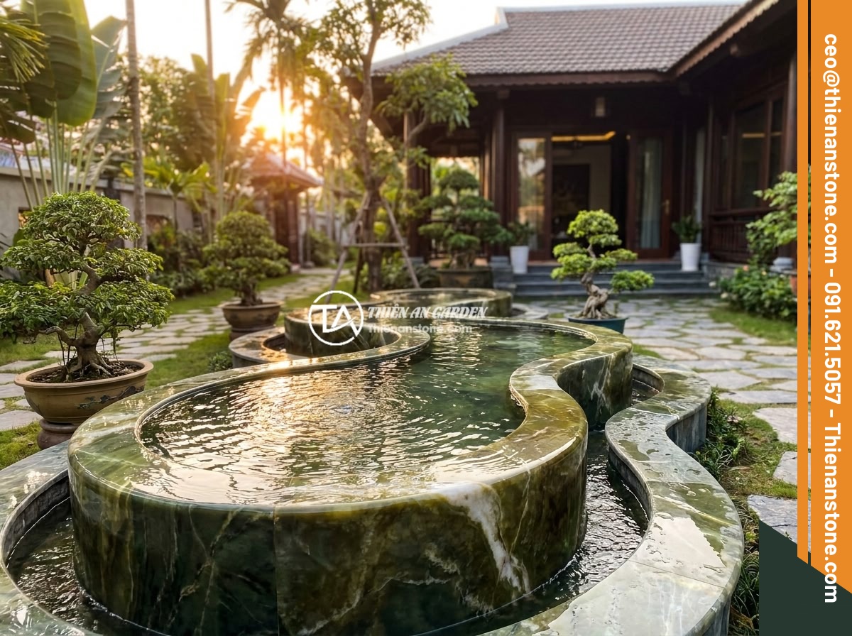 Đài Phun Nước Bằng Đá Là Gì? Cấu Tạo, Nguyên Lý Hoạt Động Và Lợi Ích Phong Thủy - Hình 9 Đài Phun Nước Bằng Đá Là Gì? Cấu Tạo, Nguyên Lý Hoạt Động Và Lợi Ích Phong Thủy - A stunning completed stone water fountain installation in front of a Vietnamese