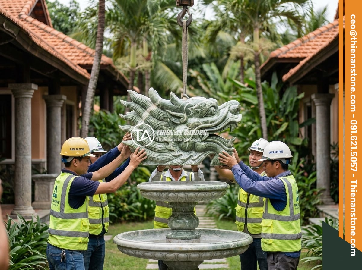 Mẫu Đài Phun Nước Bằng Đá Điêu Khắc Độc Đáo: Rồng, Cá Chép, Hoa Sen Phong Thủy - Professional team from Thien An Stone company installing a large ornate stone dr