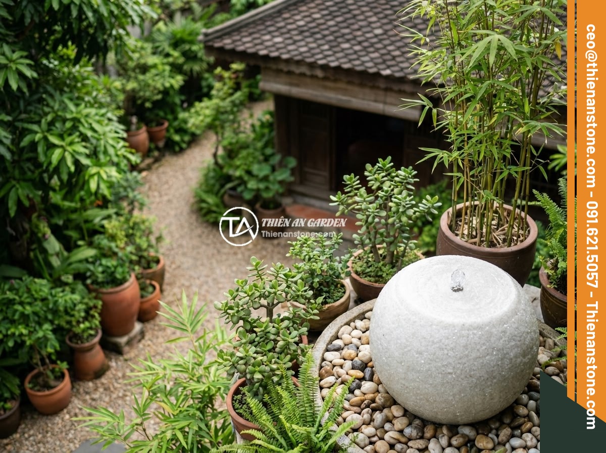 Nên Chọn Đài Phun Nước Bằng Đá Hay Bằng Đồng? So Sánh Chi Tiết Ưu Nhược Điểm - A feng shui-inspired garden layout showing a natural stone water fountain positi