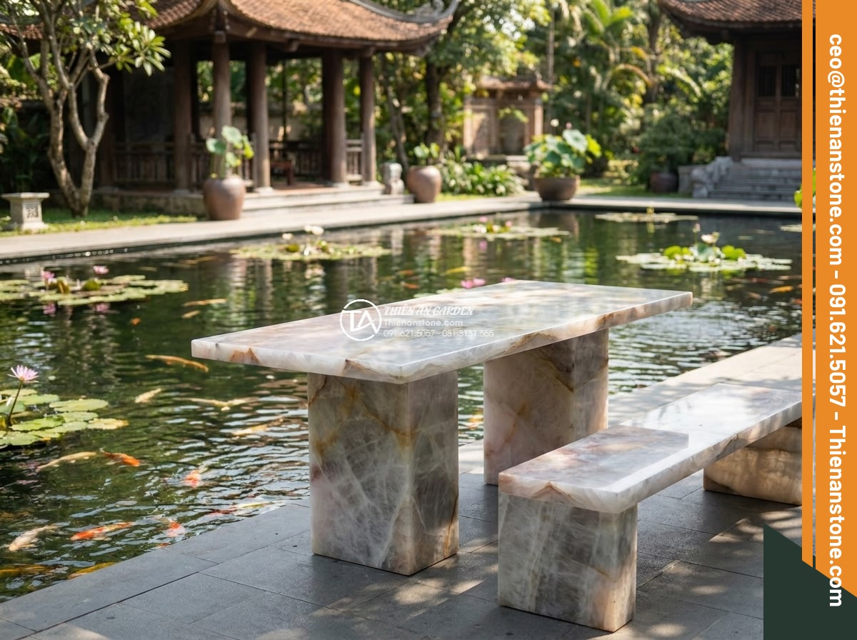 Bàn ghế đá thạch anh - Hình 10 Bàn ghế đá thạch anh - Daytime wide angle view of elegant quartz stone seating arrangement next to a la