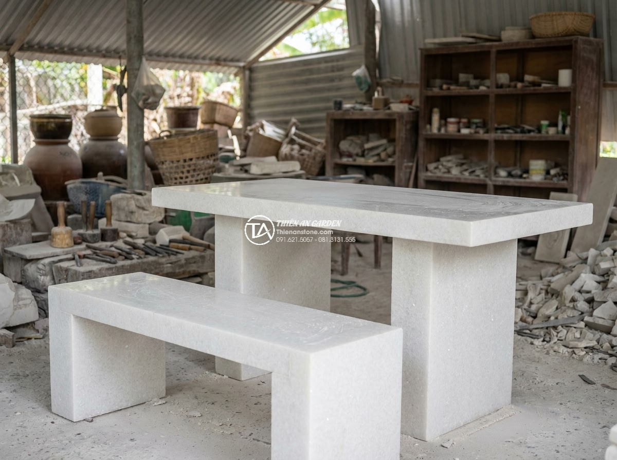 Bàn ghế đá trắng muối - Hình 17 Bàn ghế đá trắng muối - Artisan hands carving white salt stone marble into elegant chair design, worksho