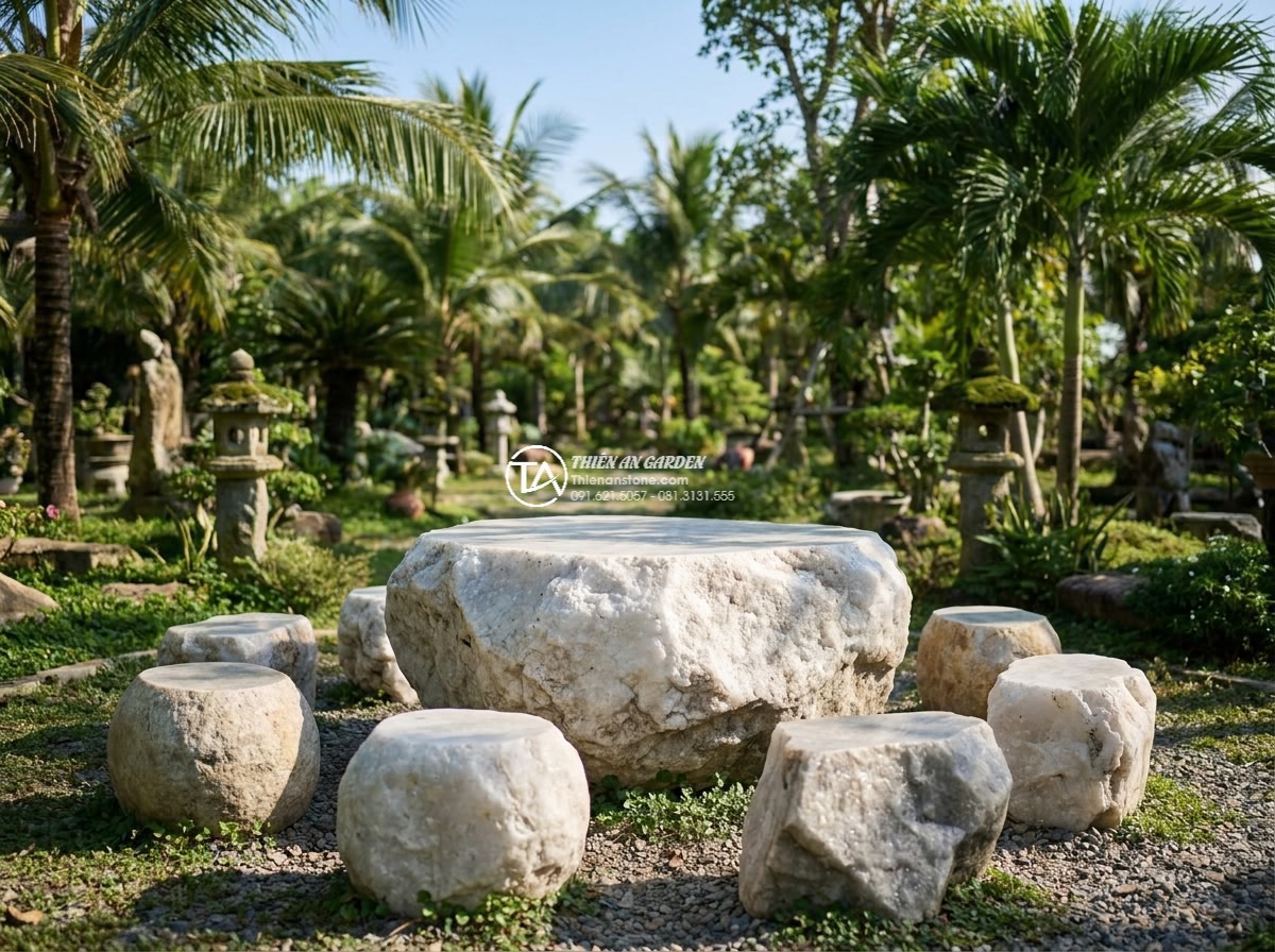 Bàn ghế đá trắng muối - Hình 3 Bàn ghế đá trắng muối - Distant perspective of white salt stone marble outdoor furniture set in expansiv