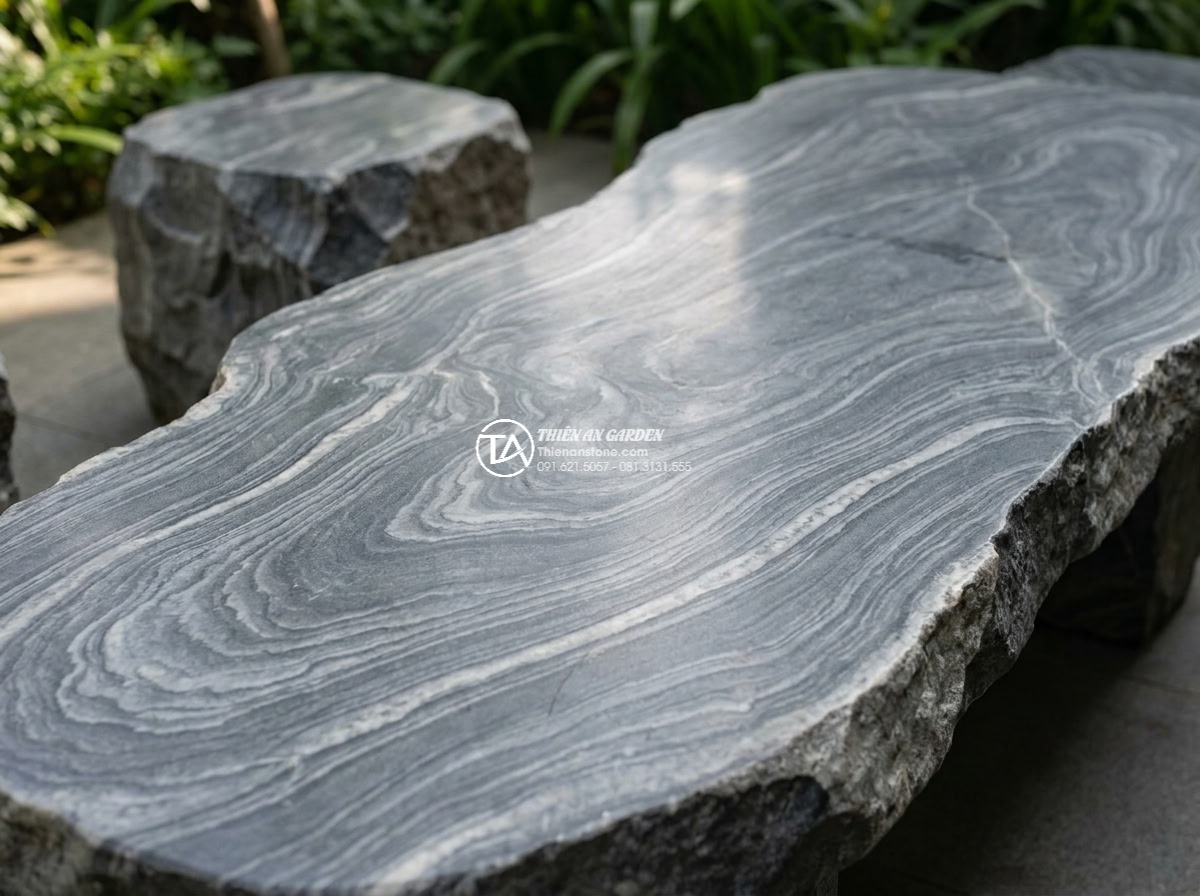 Bàn ghế đá vân mây - Hình 5 Bàn ghế đá vân mây - Close-up photorealistic detail shot of the swirling cloud-like gray veins on a p