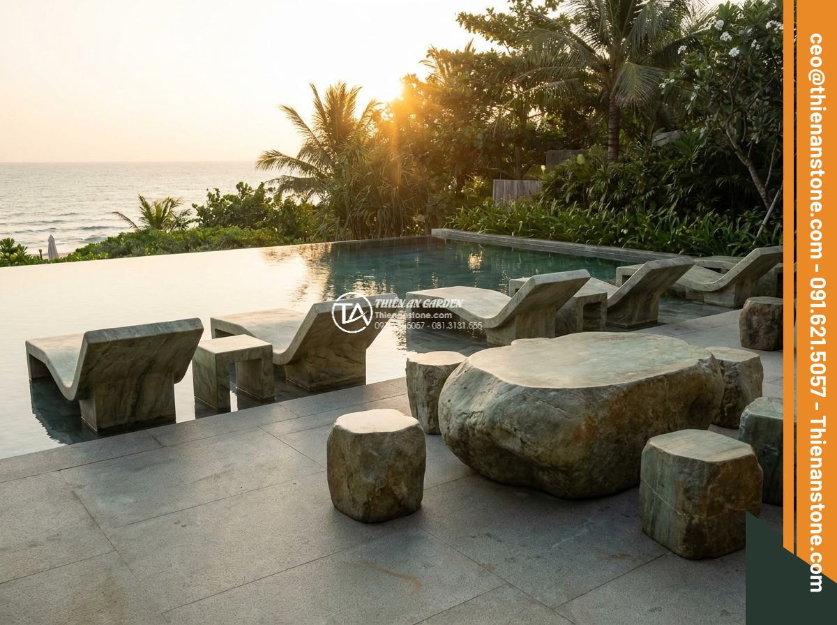 Bàn ghế đá xanh rêu - Hình 16 Bàn ghế đá xanh rêu - Resort poolside scene with elegant moss green stone lounge chairs and side table