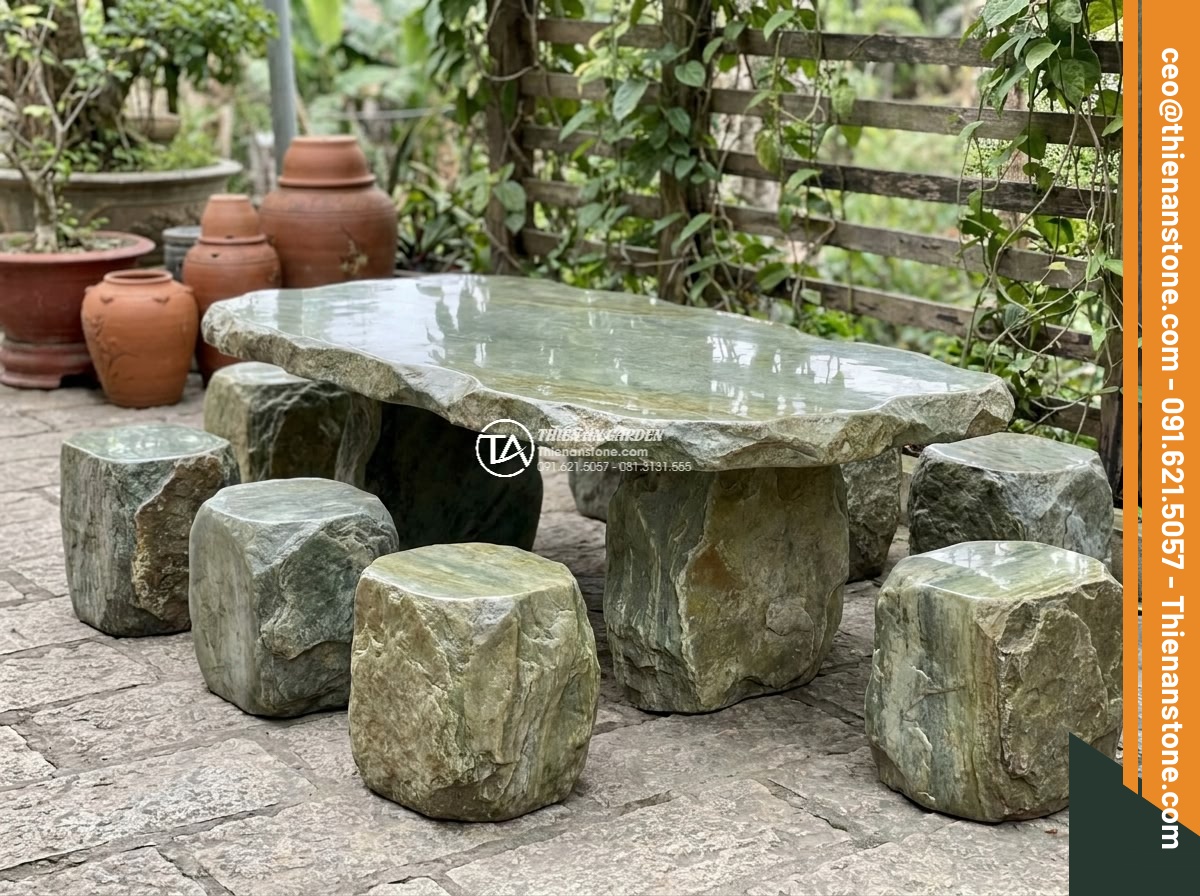 Bàn ghế đá xanh rêu - Hình 8 Bàn ghế đá xanh rêu - Three-quarter view of a complete moss green stone dining set with six chairs, sh