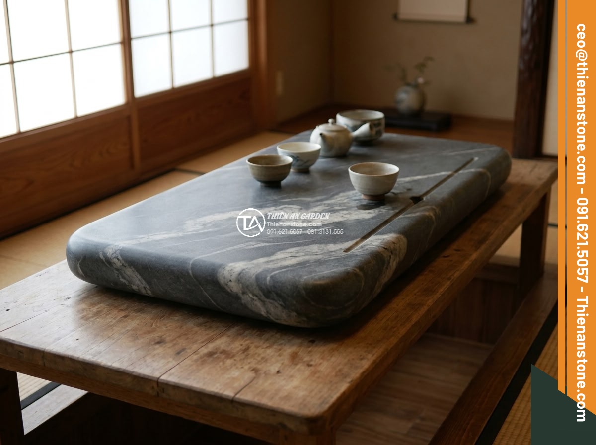 Bàn trà đá cuội - Hình 15 Bàn trà đá cuội - Luxury resort garden scene featuring a large custom pebble stone tea table as ce