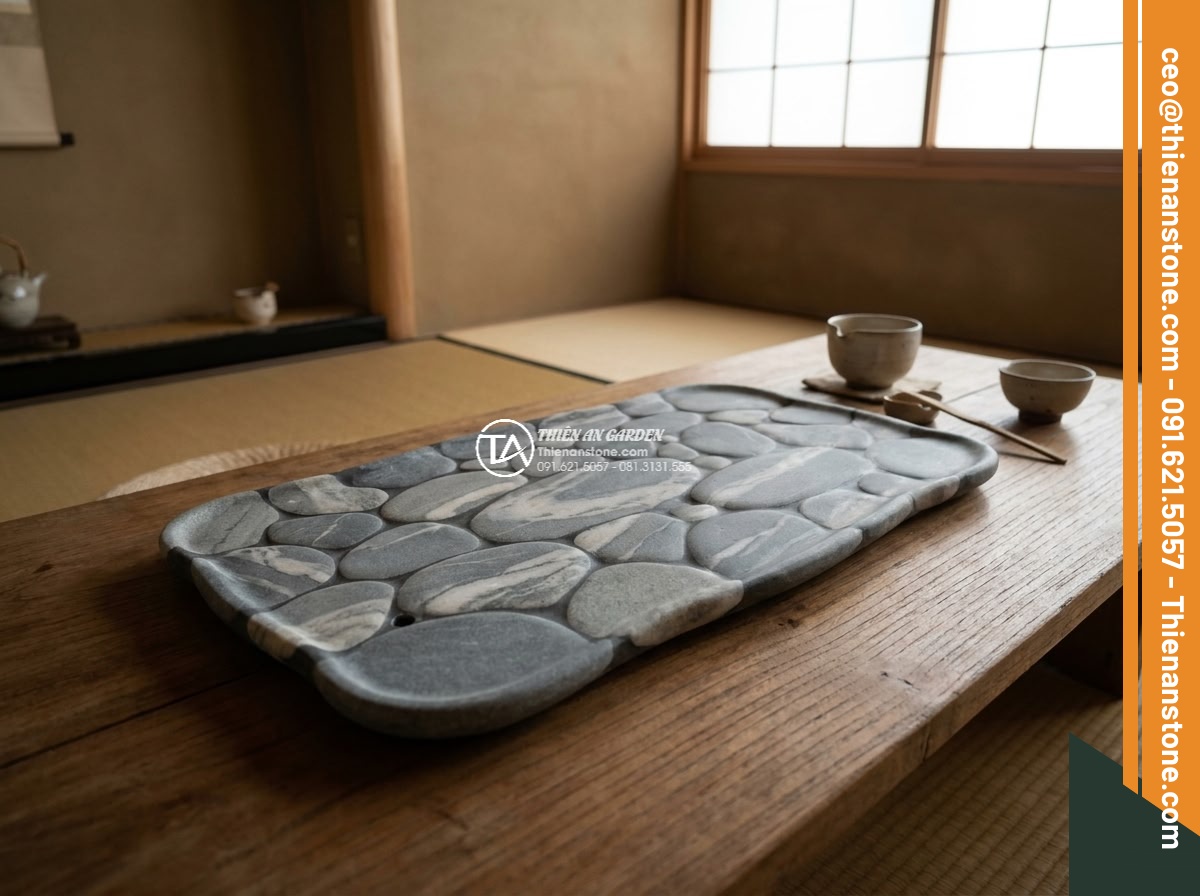 Bàn trà đá cuội - Hình 5 Bàn trà đá cuội - Wide establishing shot of an elegant pebble stone tea table integrated into a lu
