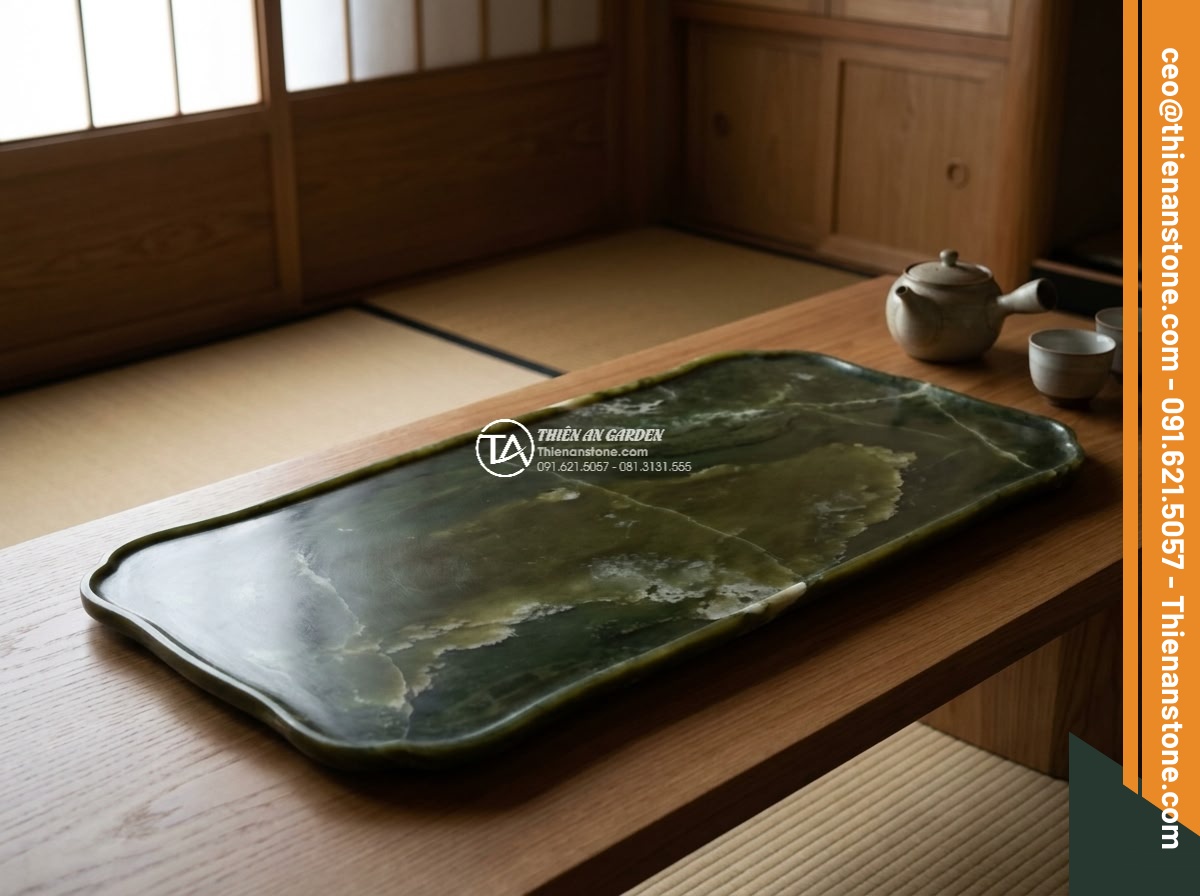 Bàn trà đá ngọc Secpentine - Hình 4 Bàn trà đá ngọc Secpentine - Close-up aerial view of a hand-polished Serpentine tea table with subtle lotus l