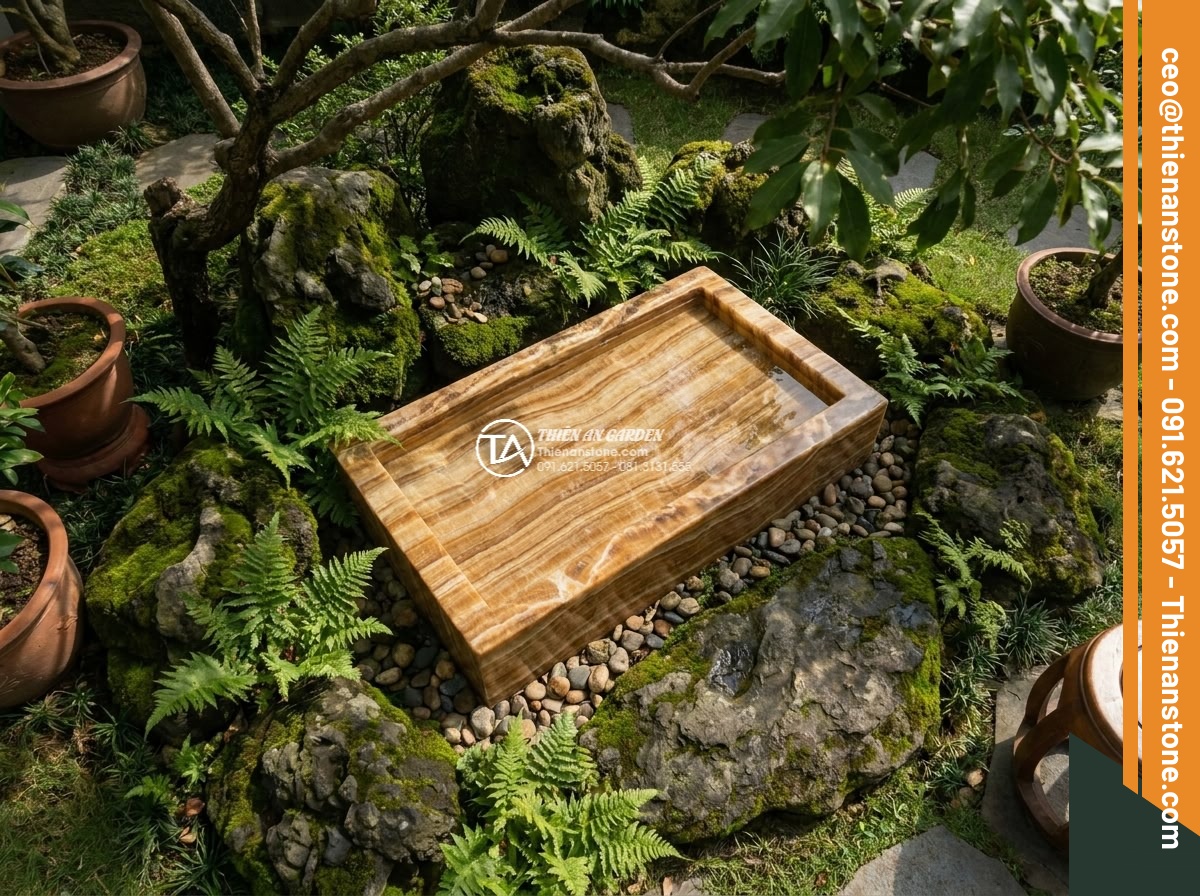 Lavabo đá vân gỗ hình trụ nông cao 15cm (400x400x150mm) - Hình 4 Lavabo đá vân gỗ hình trụ nông cao 15cm (400x400x150mm) - Aerial drone-style view overlooking a serene garden corner featuring the shallow