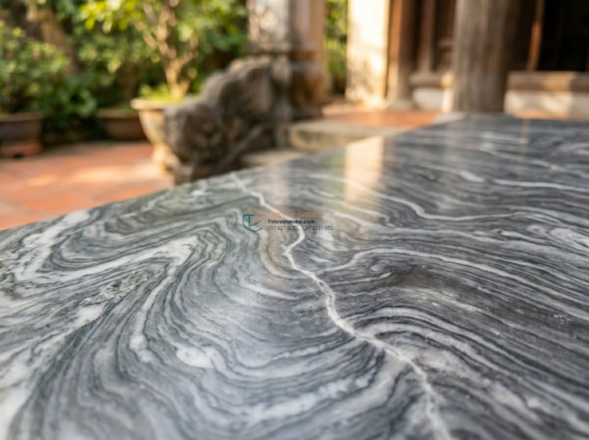 Phiến đá cầu vân mây mài bán bóng cực sang: 160 x 65 x 15 cm. - Hình 8 Phiến đá cầu vân mây mài bán bóng cực sang: 160 x 65 x 15 cm. - Tactile detail shot of fingers tracing the natural cloud patterns on the polishe
