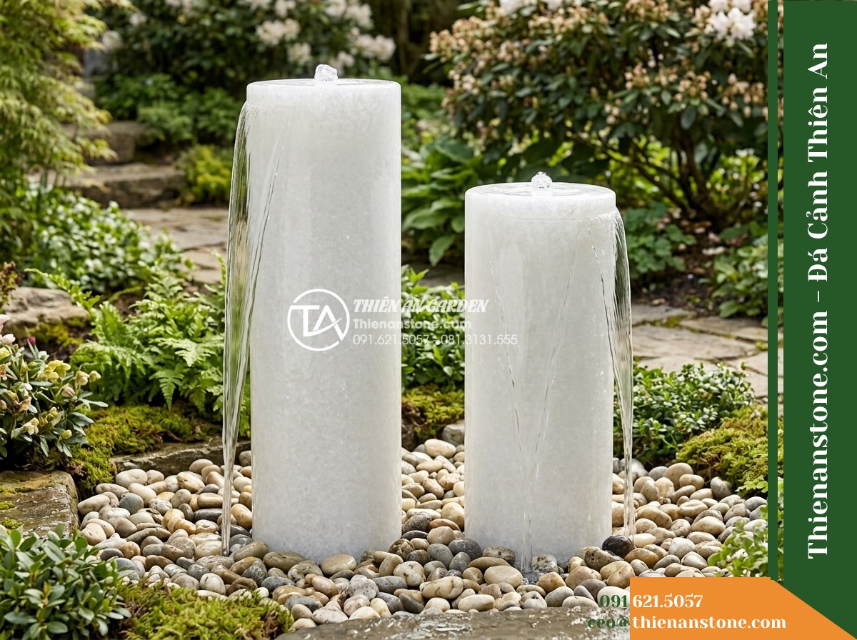 Bộ 2 Trụ Phun Tròn Đôi Mài Nhẵn, D30cm Cao 70-90cm - Hình 8 Bộ 2 Trụ Phun Tròn Đôi Mài Nhẵn, D30cm Cao 70-90cm - Side view showing both 70cm and 90cm stone water pillars running simultaneously,