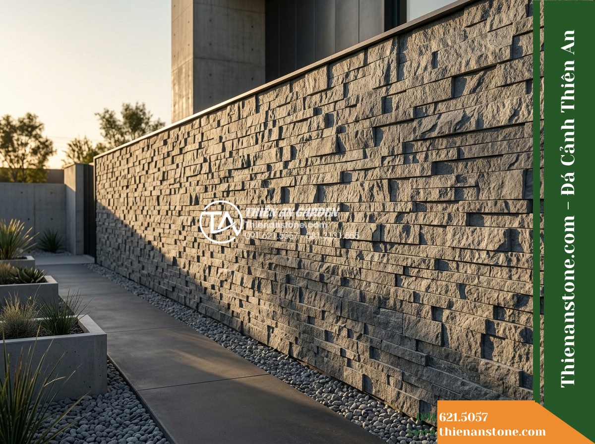 Đá ghép bazan Lâm Đồng | Bazan xám bóc thô Lâm Đồng | 10x50 cm - Hình 1 Đá ghép bazan Lâm Đồng | Bazan xám bóc thô Lâm Đồng | 10x50 cm - A long outdoor architectural feature wall cladded with split-face gray basalt mo