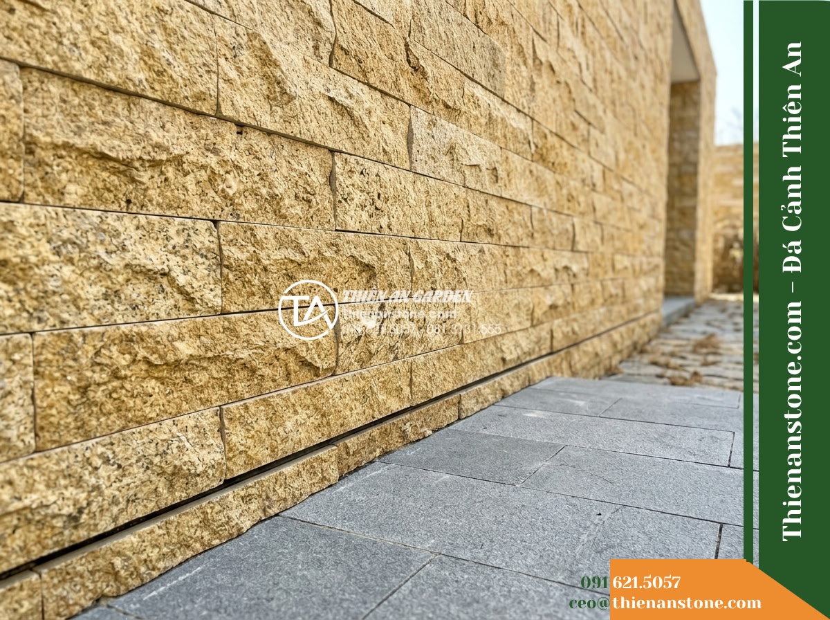 Đá ghép vàng Bình Định | Granite / Marble vàng Bình Định | 10x50 cm - Hình 9 Đá ghép vàng Bình Định | Granite / Marble vàng Bình Định | 10x50 cm - Architectural detail shot showing the lower structural junction of an exterior w