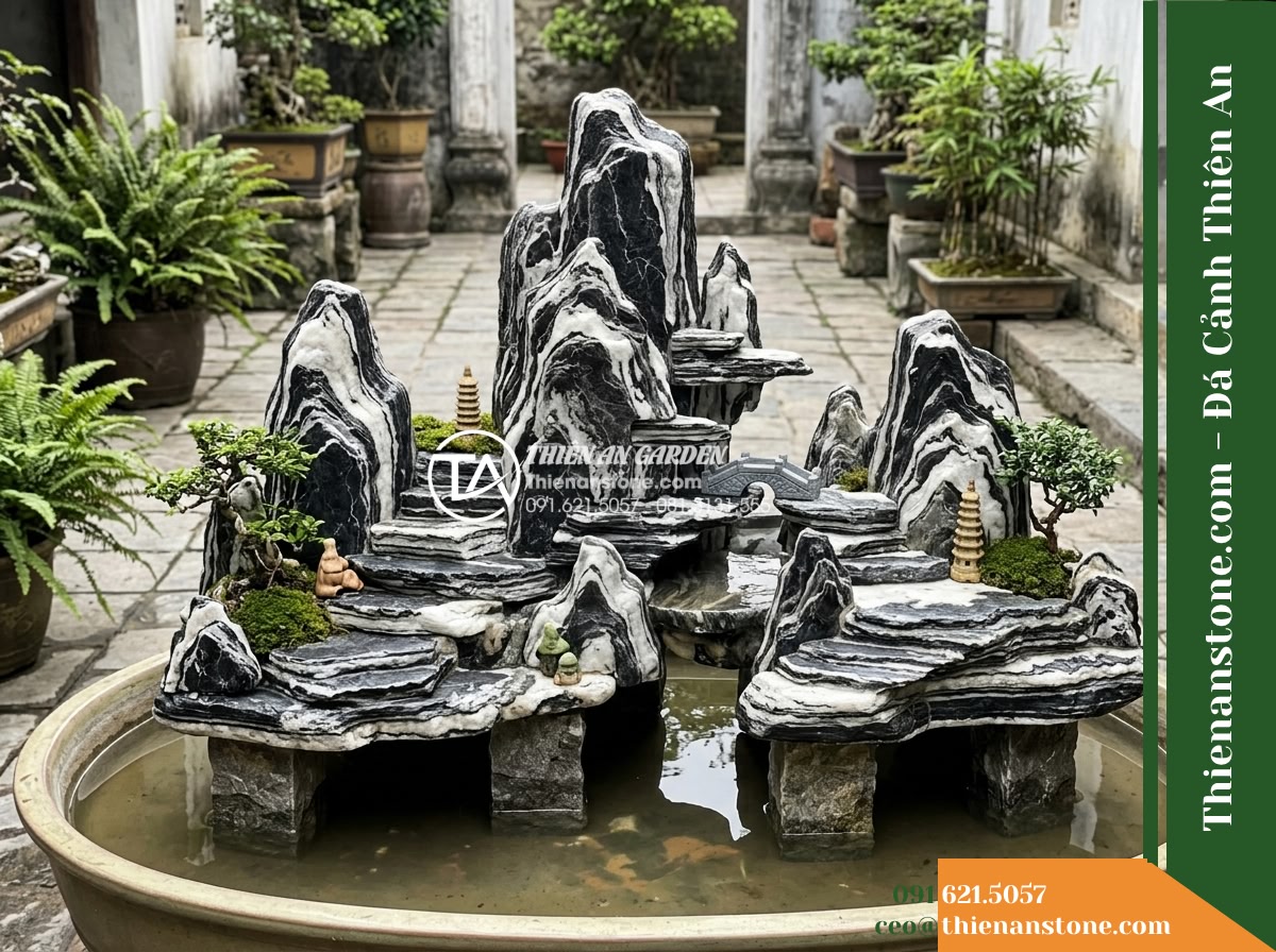 Đá Ngũ Vân Sơn (Size vừa 25–50cm) | Chuyên dựng hòn non bộ vừa. - Hình 6 Đá Ngũ Vân Sơn (Size vừa 25–50cm) | Chuyên dựng hòn non bộ vừa. - Slight high-angle view of an assembled miniature rockery layout using stones fro