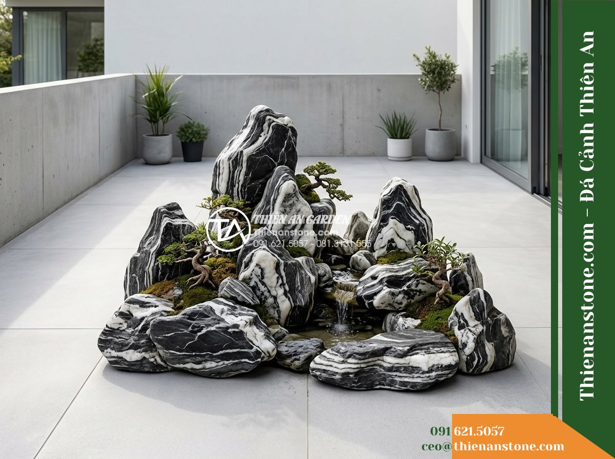 Đá Ngũ Vân Sơn (Size vừa 25–50cm) | Chuyên dựng hòn non bộ vừa. - Hình 8 Đá Ngũ Vân Sơn (Size vừa 25–50cm) | Chuyên dựng hòn non bộ vừa. - Wide angle architectural view of a small residential stone terrace, showing the