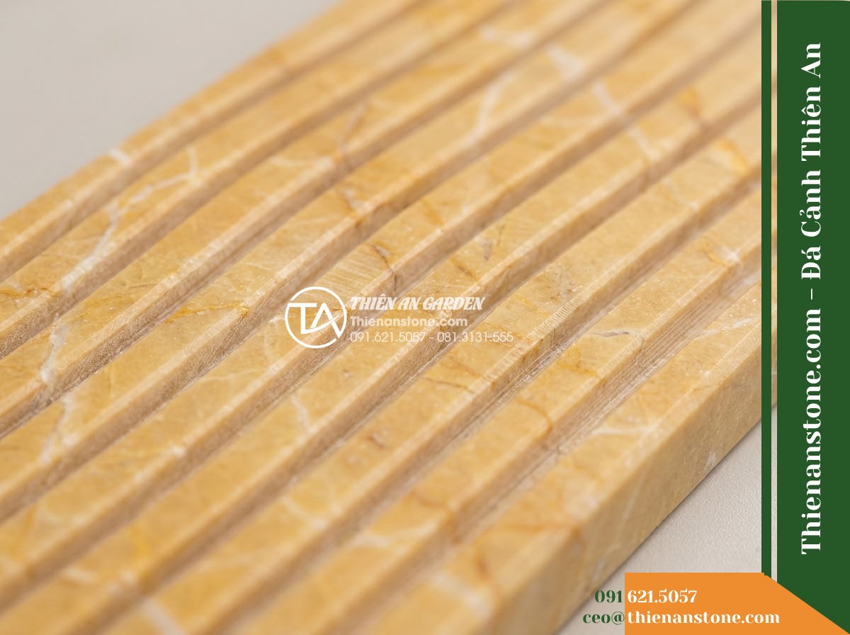 Đá răng lược vàng Nghệ An | Marble vàng Nghệ An | 10x50 cm - Hình 3 Đá răng lược vàng Nghệ An | Marble vàng Nghệ An | 10x50 cm - A macro close-up photograph of a natural yellow Marble comb-cut textured stone s