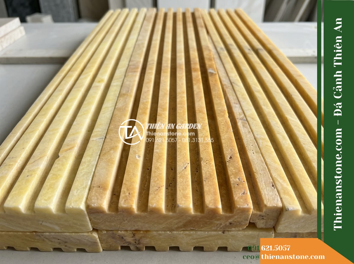 Đá răng lược vàng Nghệ An | Marble vàng Nghệ An | 10x50 cm - Hình 4 Đá răng lược vàng Nghệ An | Marble vàng Nghệ An | 10x50 cm - A close-up shot showing multiple slabs of yellow fluted stone placed together, h