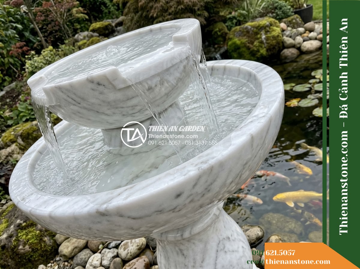 Đài Phun 2 Bát Tròn Chảy Tràn Hồ Koi, Bát D60cm Cao 1m - Hình 2 Đài Phun 2 Bát Tròn Chảy Tràn Hồ Koi, Bát D60cm Cao 1m - Diagonal perspective close-up of a two-tier circular stone fountain showing clea