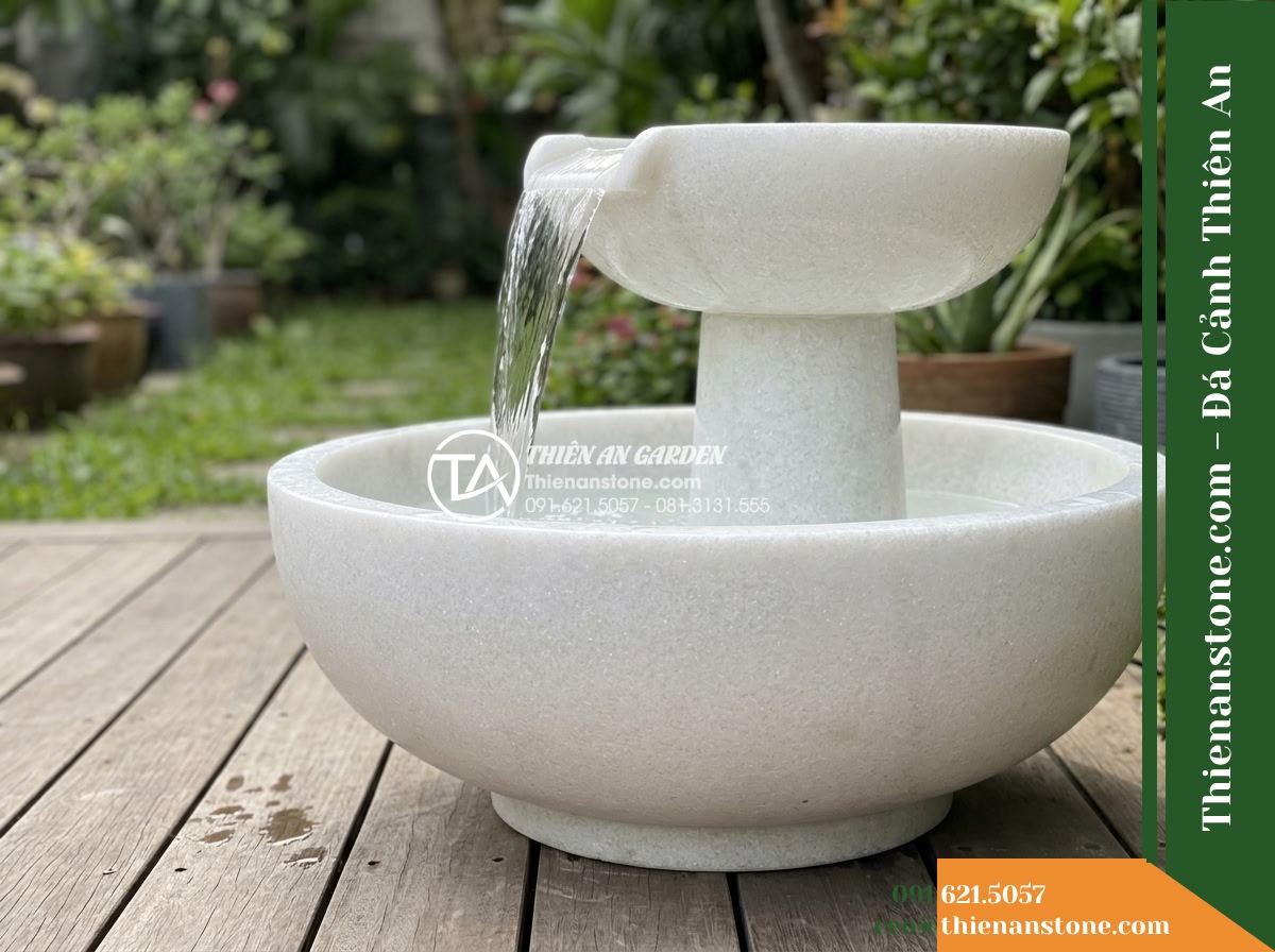 Đài Phun 2 Tầng Bát Sơ Khai Lòng Mịn, Bát D80cm Cao 1.1m - Hình 8 Đài Phun 2 Tầng Bát Sơ Khai Lòng Mịn, Bát D80cm Cao 1.1m - A side profile view showing the graceful water cascade falling from the upper ba