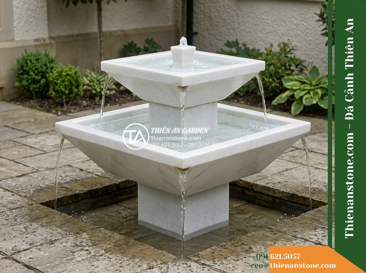 Đài Phun Bát Vuông 2 Tầng Tràn Bốn Góc, Bát D70cm Cao 1m - Hình 1 Đài Phun Bát Vuông 2 Tầng Tràn Bốn Góc, Bát D70cm Cao 1m - A wide eye-level outdoor photograph of a two-tier square stone water fountain st