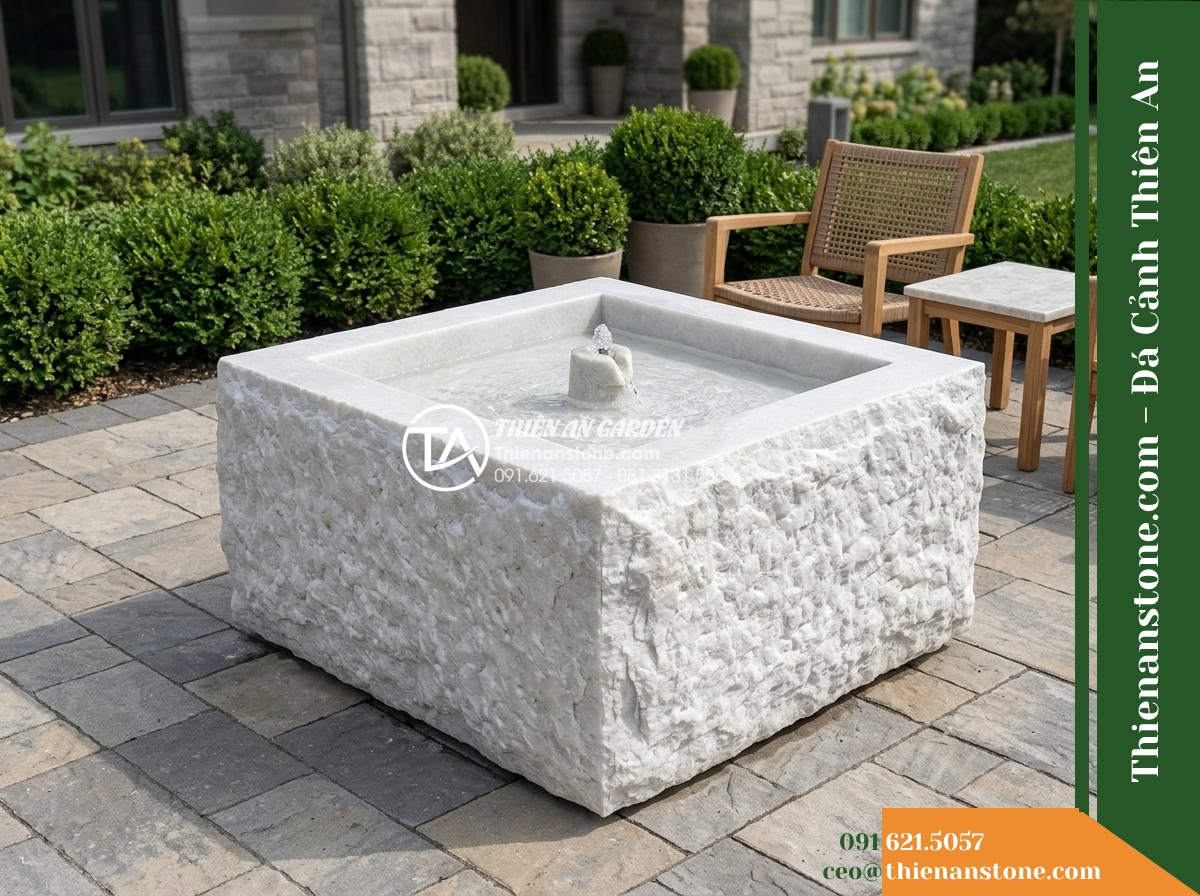 Đài Phun Bát Vuông Lòng Mài Mịn Vỏ Thô, Bát D80cm Cao 75cm - Hình 5 Đài Phun Bát Vuông Lòng Mài Mịn Vỏ Thô, Bát D80cm Cao 75cm - Eye-level realistic photo of the 75cm high square stone fountain standing in a p