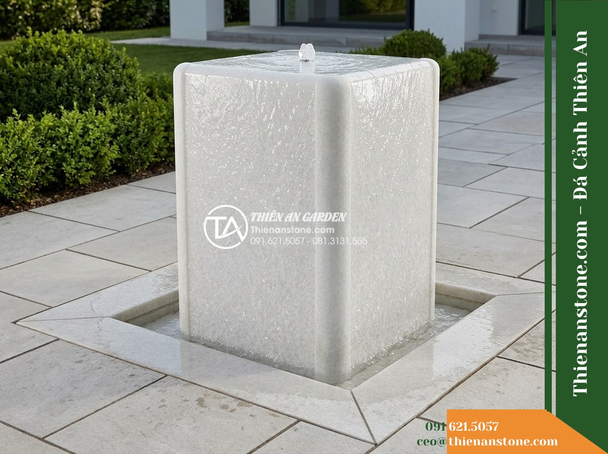 Đài Phun Khối Bo Vuông Khò Mặt Nước, 60x60cm Cao 90cm - Hình 19 Đài Phun Khối Bo Vuông Khò Mặt Nước, 60x60cm Cao 90cm - Comprehensive overview photograph showing the stone water feature seamlessly int