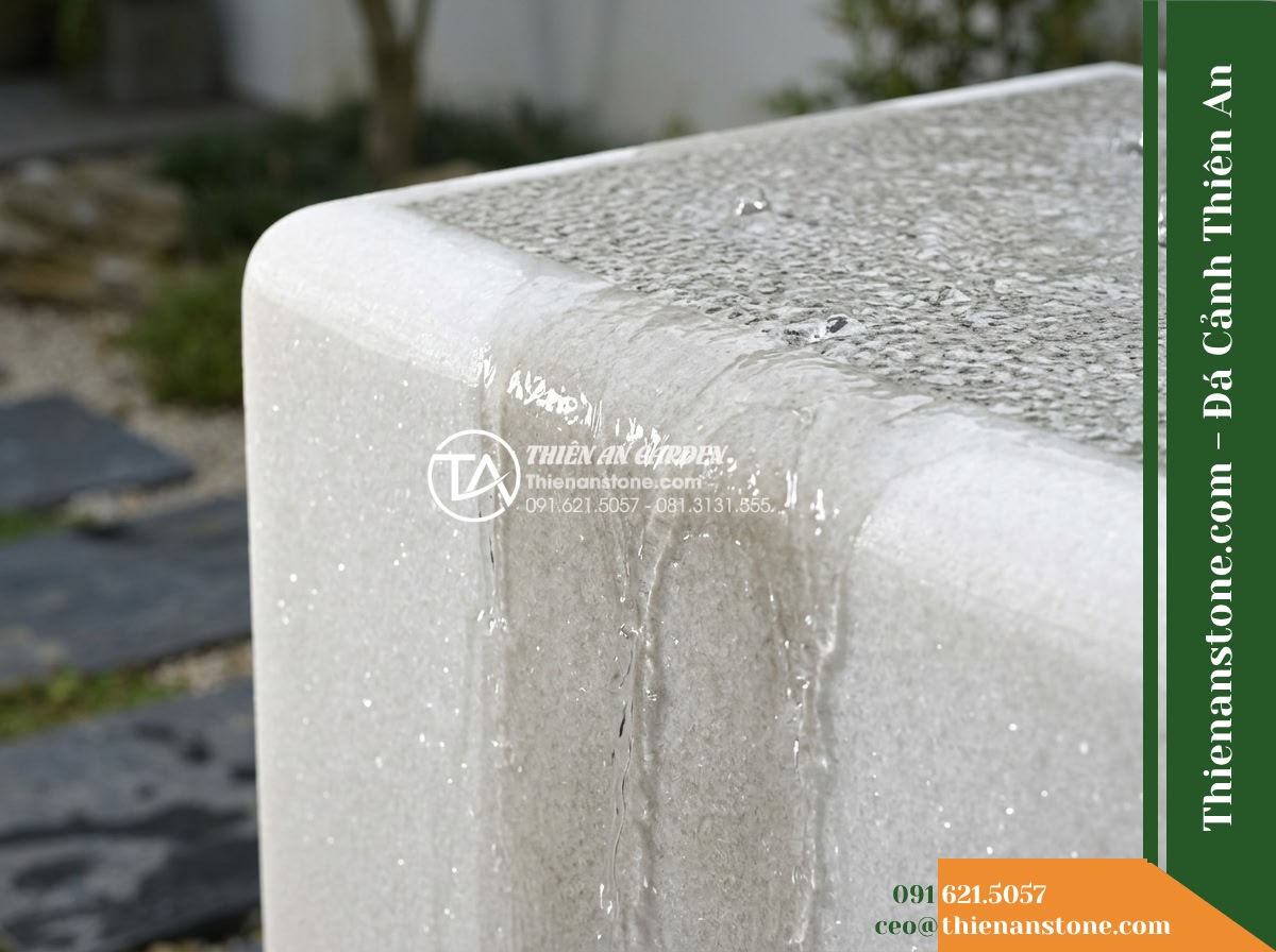 Đài Phun Khối Bo Vuông Khò Mặt Nước, 60x60cm Cao 90cm - Hình 2 Đài Phun Khối Bo Vuông Khò Mặt Nước, 60x60cm Cao 90cm - Close-up diagonal view focusing on the hand-finished rounded square edge of a na