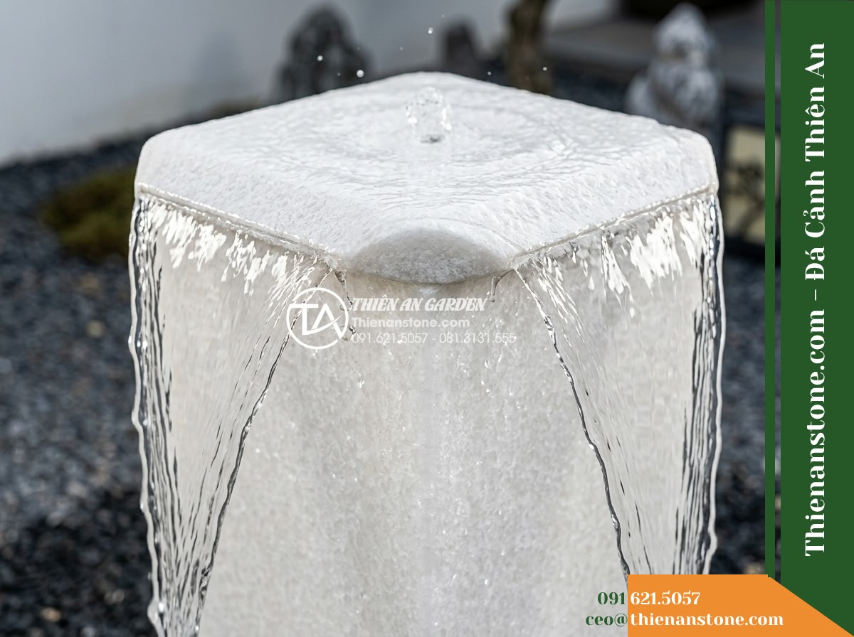 Đài Phun Khối Bo Vuông Khò Mặt Nước, 60x60cm Cao 90cm - Hình 7 Đài Phun Khối Bo Vuông Khò Mặt Nước, 60x60cm Cao 90cm - Detailed close-up capture of water brimming over the flamed stone top plate, sli
