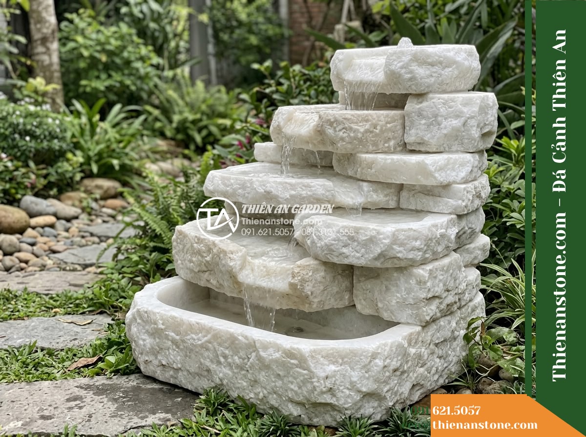 Đài Phun Khối Suối Xếp Tầng Mộc Mạc, D70cm Cao 80cm - Hình 2 Đài Phun Khối Suối Xếp Tầng Mộc Mạc, D70cm Cao 80cm - Diagonal perspective of the rustic tiered rock fountain showing natural hand-chi