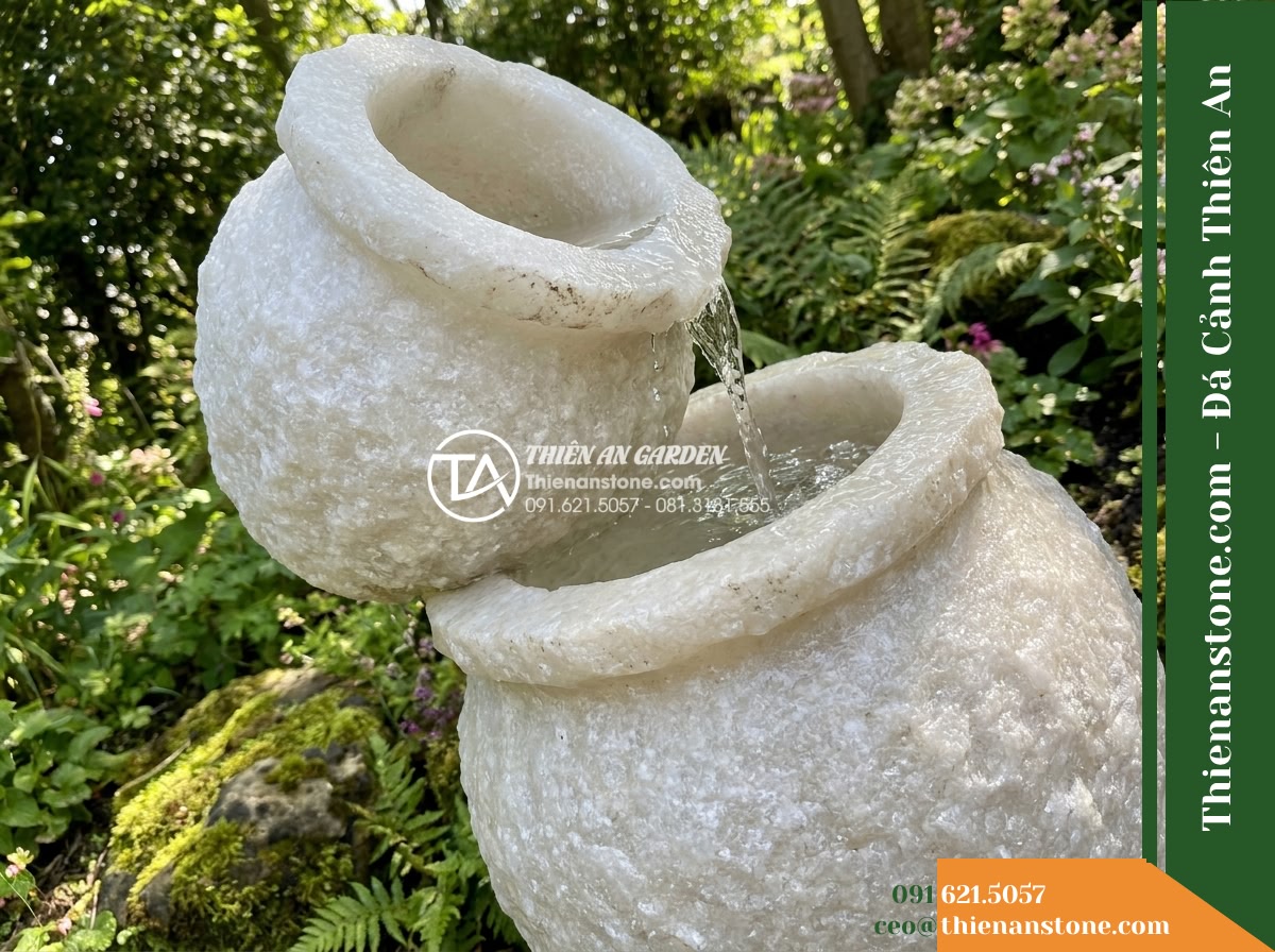 Đài Phun Lu Nước Xếp 2 Tầng Lệch, D40cm Cao 90cm - Hình 2 Đài Phun Lu Nước Xếp 2 Tầng Lệch, D40cm Cao 90cm - Diagonal perspective focusing on the staggered alignment of two hand-carved ston