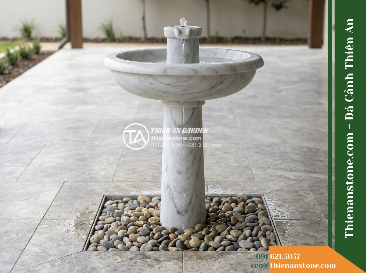 Đài Phun Trắng Mịn Vành Bo Tròn Lụa, Bát D80cm Cao 1.2m - Hình 8 Đài Phun Trắng Mịn Vành Bo Tròn Lụa, Bát D80cm Cao 1.2m - Side elevation photo showing the 1.2m tall fountain standing over a discrete rec
