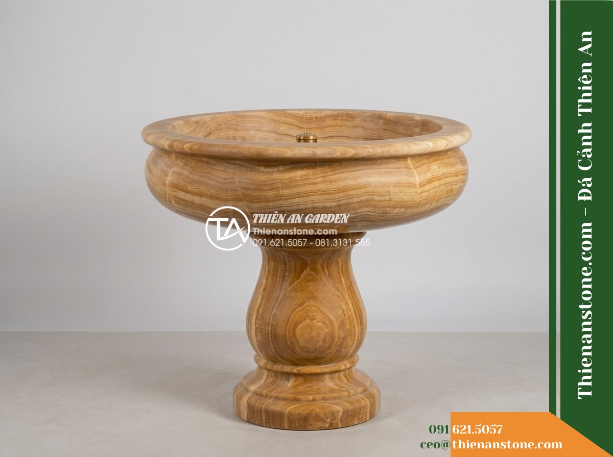 Đài Phun Vàng Cam Mài Nhẵn Bề Mặt, Bát D90cm Cao 1.2m - Hình 11 Đài Phun Vàng Cam Mài Nhẵn Bề Mặt, Bát D90cm Cao 1.2m - A solo studio portrait of the yellow-orange honed stone fountain against a neutr
