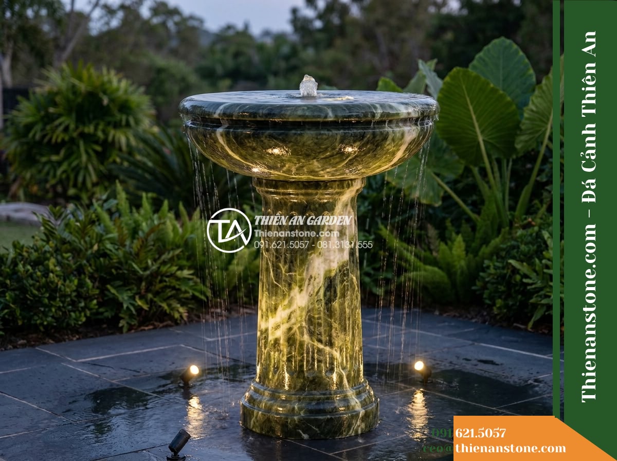 Đài Phun Xanh Thấu Quang Đỉnh Phun, Bát D85cm Cao 1.3m - Hình 1 Đài Phun Xanh Thấu Quang Đỉnh Phun, Bát D85cm Cao 1.3m - A wide-angle evening shot of an elegant 1.3-meter-tall green stone water fountai