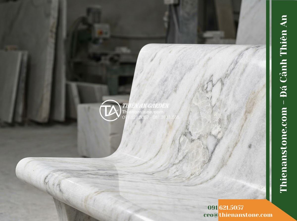 Ghế Đá Công Viên Có Tựa Bo Mềm Phúc Khang 150x50x82cm - Đá Vàng Cẩm Thạch - Hình 5 Ghế Đá Công Viên Có Tựa Bo Mềm Phúc Khang 150x50x82cm - Đá Vàng Cẩm Thạch - Professional installation of a golden marble stone bench in a landscaped garden,