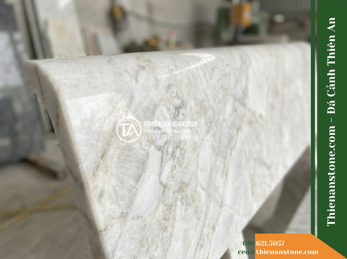Ghế Đá Công Viên Có Tựa Song Ngang Gia Hưng 150x50x88cm - Đá Vàng Cẩm Thạch - Hình 2 Ghế Đá Công Viên Có Tựa Song Ngang Gia Hưng 150x50x88cm - Đá Vàng Cẩm Thạch - Aerial view of a golden marble stone bench positioned beside a koi pond in a lux
