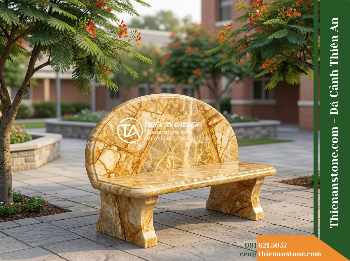 Ghế Đá Công Viên Có Tựa Tròn Viền Thanh Lộc 140x50x82cm - Đá Vàng Cẩm Thạch - Hình 2 Ghế Đá Công Viên Có Tựa Tròn Viền Thanh Lộc 140x50x82cm - Đá Vàng Cẩm Thạch - Elegant golden marble stone bench in a school courtyard, flanked by phoenix flow