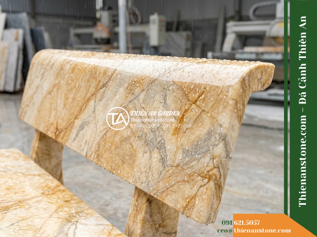 Ghế Đá Công Viên Có Tựa Tròn Viền Thanh Lộc 140x50x82cm - Đá Vàng Cẩm Thạch - Hình 3 Ghế Đá Công Viên Có Tựa Tròn Viền Thanh Lộc 140x50x82cm - Đá Vàng Cẩm Thạch - golden marble stone bench during light rain, water droplets on polished surface
