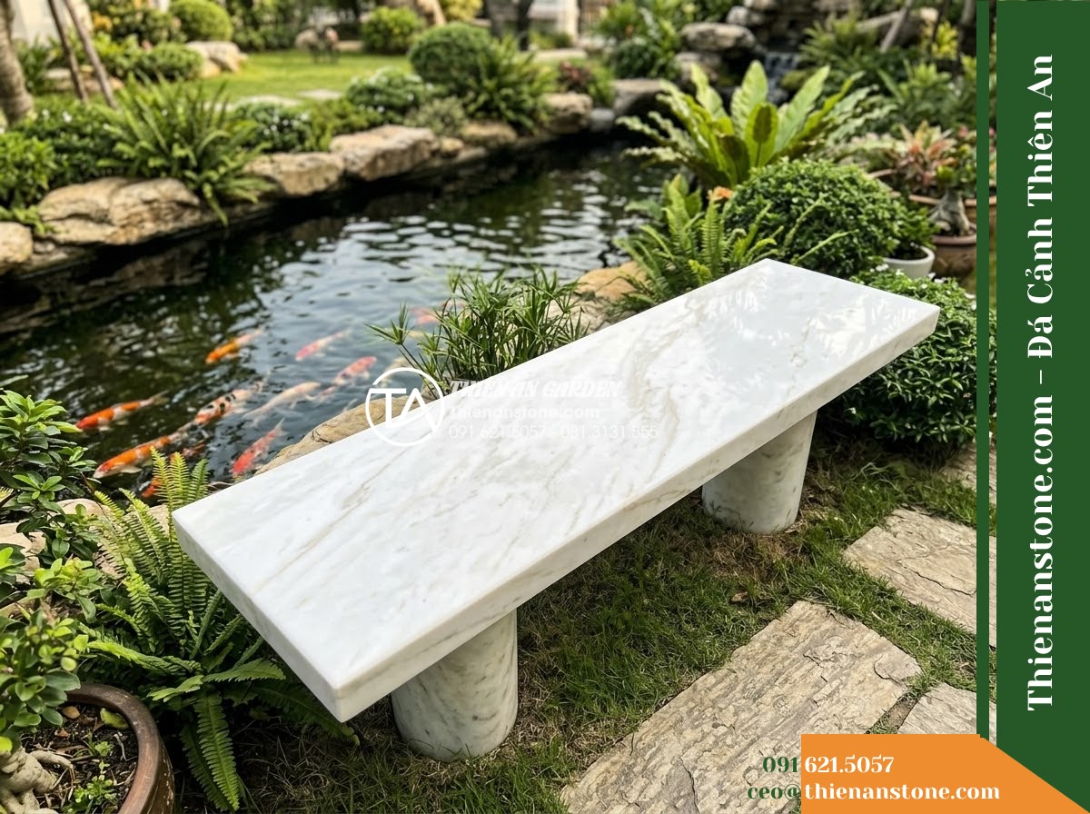 Ghế Đá Công Viên Không Tựa Chân Trụ Bình An 150x45x45cm - Đá Trắng Cẩm Thạch - Hình 2 Ghế Đá Công Viên Không Tựa Chân Trụ Bình An 150x45x45cm - Đá Trắng Cẩm Thạch - Aerial view of a white marble stone bench positioned beside a koi pond in a luxu