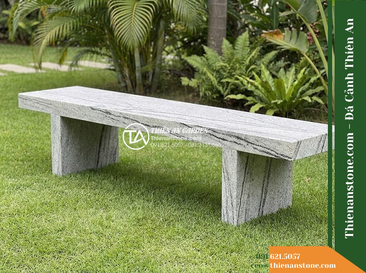 Ghế Đá Granite Nguyên Khối Khải Minh – Kích thước 185 x 45 x 45 cm – Kiểu dáng thanh dài, chân chữ T kép. Chất liệu đá granite - Hình 2 Ghế Đá Granite Nguyên Khối Khải Minh – Kích thước 185 x 45 x 45 cm – Kiểu dáng thanh dài, chân chữ T kép. Chất liệu đá granite - natural granite stone bench with natural veins, sitting on a manicured lawn with
