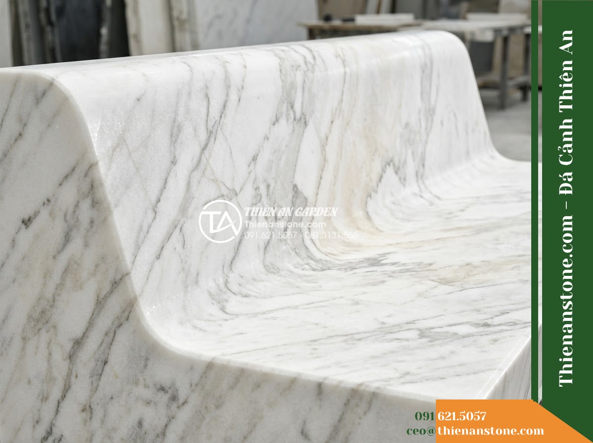 Ghế Đá Granite Nguyên Khối Thanh Phong – Kích thước 155 x 45 x 45 cm – Kiểu dáng mặt cong nhẹ theo chiều dài, chân đôi. Chất liệu đá granite - Hình 2 Ghế Đá Granite Nguyên Khối Thanh Phong – Kích thước 155 x 45 x 45 cm – Kiểu dáng mặt cong nhẹ theo chiều dài, chân đôi. Chất liệu đá granite - Aerial view of a natural granite stone bench positioned beside a koi pond in a l
