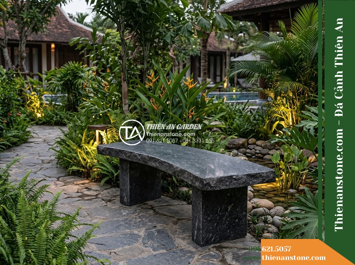 Ghế Đá Granite Nguyên Khối Thanh Phong – Kích thước 155 x 45 x 45 cm – Kiểu dáng mặt cong nhẹ theo chiều dài, chân đôi. Chất liệu đá granite - Hình 4 Ghế Đá Granite Nguyên Khối Thanh Phong – Kích thước 155 x 45 x 45 cm – Kiểu dáng mặt cong nhẹ theo chiều dài, chân đôi. Chất liệu đá granite - A natural granite stone bench integrated into a Vietnamese luxury resort landsca