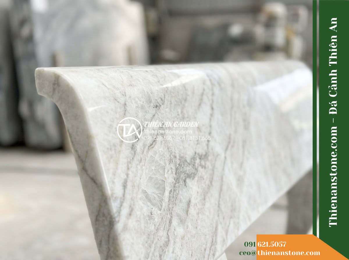 Ghế Đá Granite Nguyên Khối Tường An – Kích thước 160 x 42 x 44 cm – Kiểu dáng thấp gọn, mặt vuông cạnh tinh giản. Chất liệu đá granite - Hình 3 Ghế Đá Granite Nguyên Khối Tường An – Kích thước 160 x 42 x 44 cm – Kiểu dáng thấp gọn, mặt vuông cạnh tinh giản. Chất liệu đá granite - natural granite stone bench flanked by potted bonsai trees on a resort terrace o