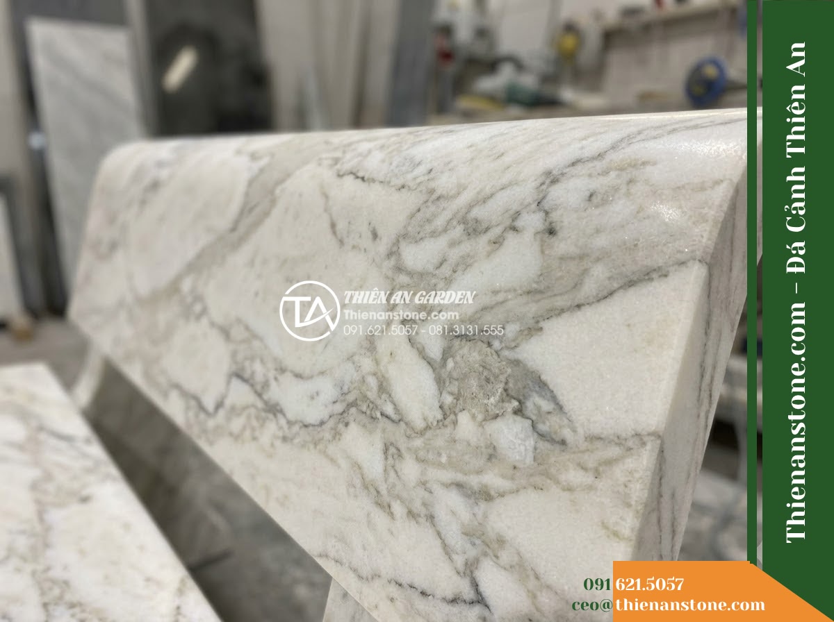 Ghế Đá Granite Nguyên Khối Vĩnh Phúc – Kích thước 175 x 47 x 45 cm – Kiểu dáng mặt chữ nhật, chân khối tạo khe thoáng. Chất liệu đá granite - Hình 4 Ghế Đá Granite Nguyên Khối Vĩnh Phúc – Kích thước 175 x 47 x 45 cm – Kiểu dáng mặt chữ nhật, chân khối tạo khe thoáng. Chất liệu đá granite - A natural granite stone bench integrated into a Vietnamese luxury resort landsca