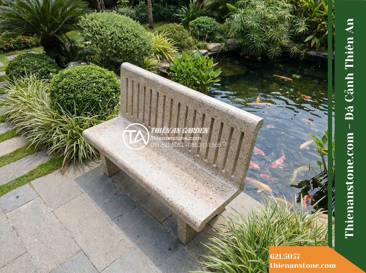 Ghế Đá Granito Bình Minh – Kích thước 160 x 50 x 80 cm – Kiểu dáng tựa nan chữ nhật, cạnh mềm mại. Chất liệu đá granito (đá mài) - Hình 2 Ghế Đá Granito Bình Minh – Kích thước 160 x 50 x 80 cm – Kiểu dáng tựa nan chữ nhật, cạnh mềm mại. Chất liệu đá granito (đá mài) - Aerial view of a granito polished stone stone bench positioned beside a koi pond