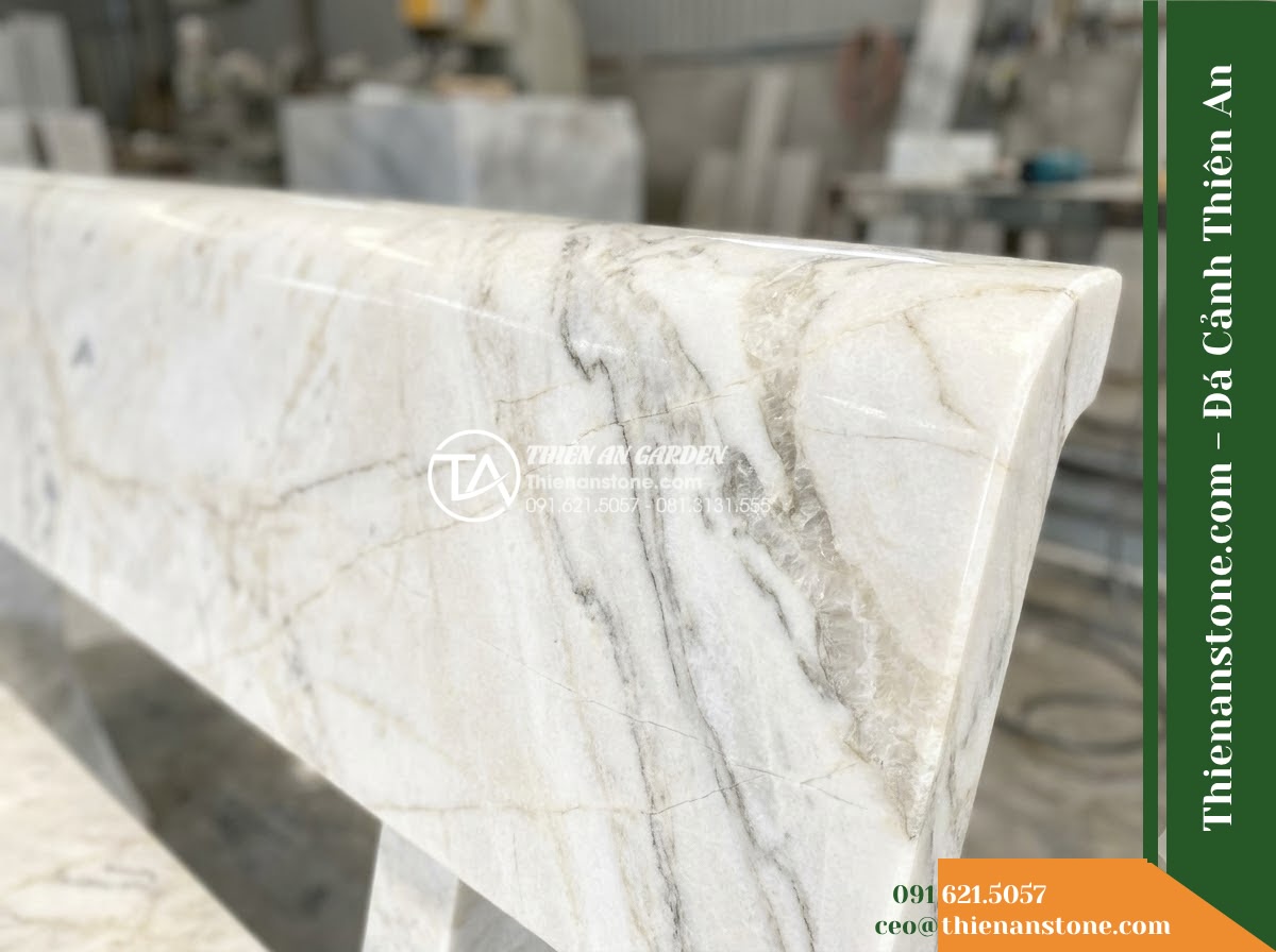 Ghế Đá Granito Kim An – Kích thước 145 x 44 x 45 cm – Kiểu dáng không tựa nhỏ gọn, cạnh bo tròn. Chất liệu đá granito (đá mài) - Hình 2 Ghế Đá Granito Kim An – Kích thước 145 x 44 x 45 cm – Kiểu dáng không tựa nhỏ gọn, cạnh bo tròn. Chất liệu đá granito (đá mài) - Aerial view of a granito polished stone stone bench positioned beside a koi pond