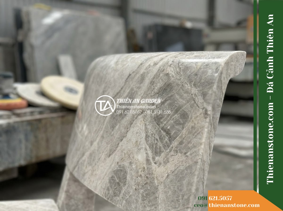 Ghế Đá Granito Minh Phát – Kích thước 180 x 50 x 80 cm – Kiểu dáng tựa nan ngang lớn, tay vịn cong. Chất liệu đá granito (đá mài) - Hình 3 Ghế Đá Granito Minh Phát – Kích thước 180 x 50 x 80 cm – Kiểu dáng tựa nan ngang lớn, tay vịn cong. Chất liệu đá granito (đá mài) - Stone bench of granito polished stone beside a cascading water feature at night,
