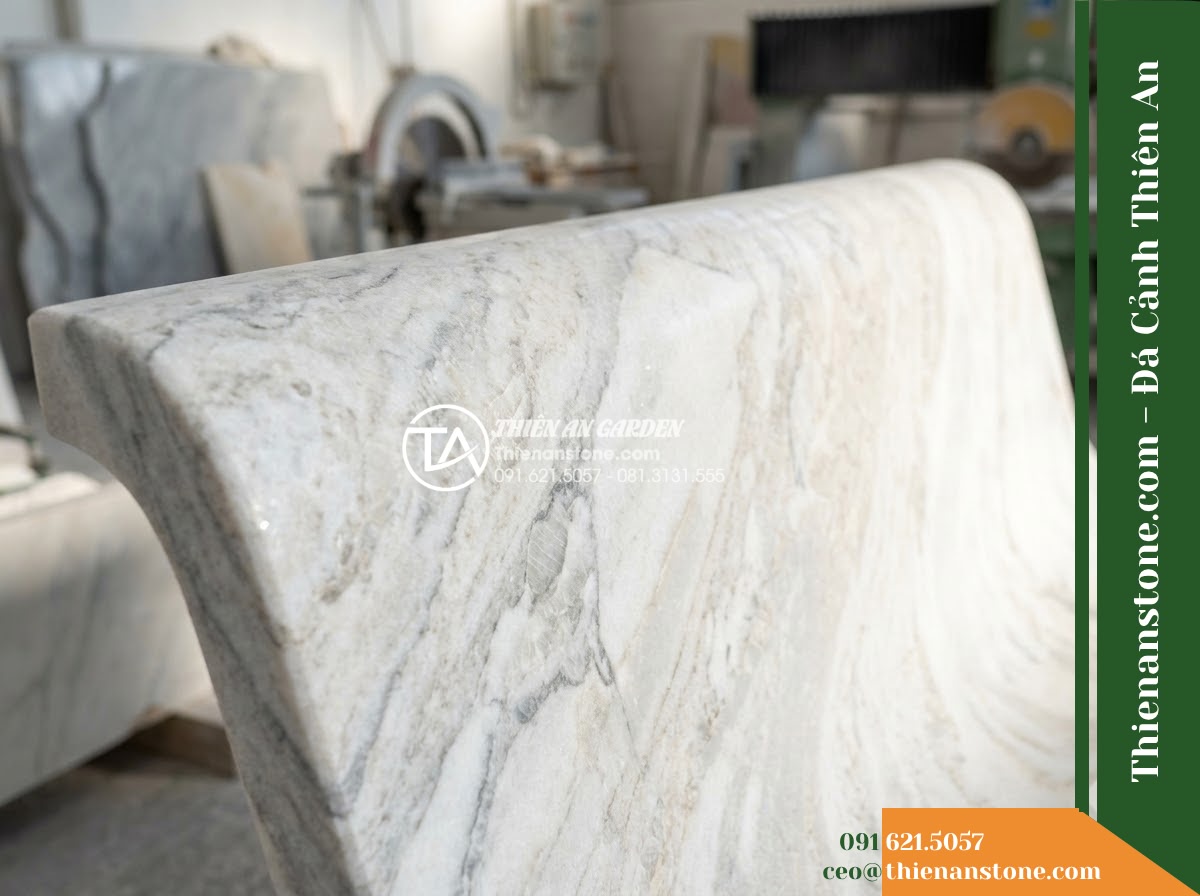 Ghế Đá Sân Trường Thành Tài – Kích thước 180 x 48 x 80 cm – Kiểu dáng tựa liền rộng, mặt ngồi phẳng. Chất liệu đá Xanh rêu - Hình 2 Ghế Đá Sân Trường Thành Tài – Kích thước 180 x 48 x 80 cm – Kiểu dáng tựa liền rộng, mặt ngồi phẳng. Chất liệu đá Xanh rêu - Aerial view of a green moss stone stone bench positioned beside a koi pond in a
