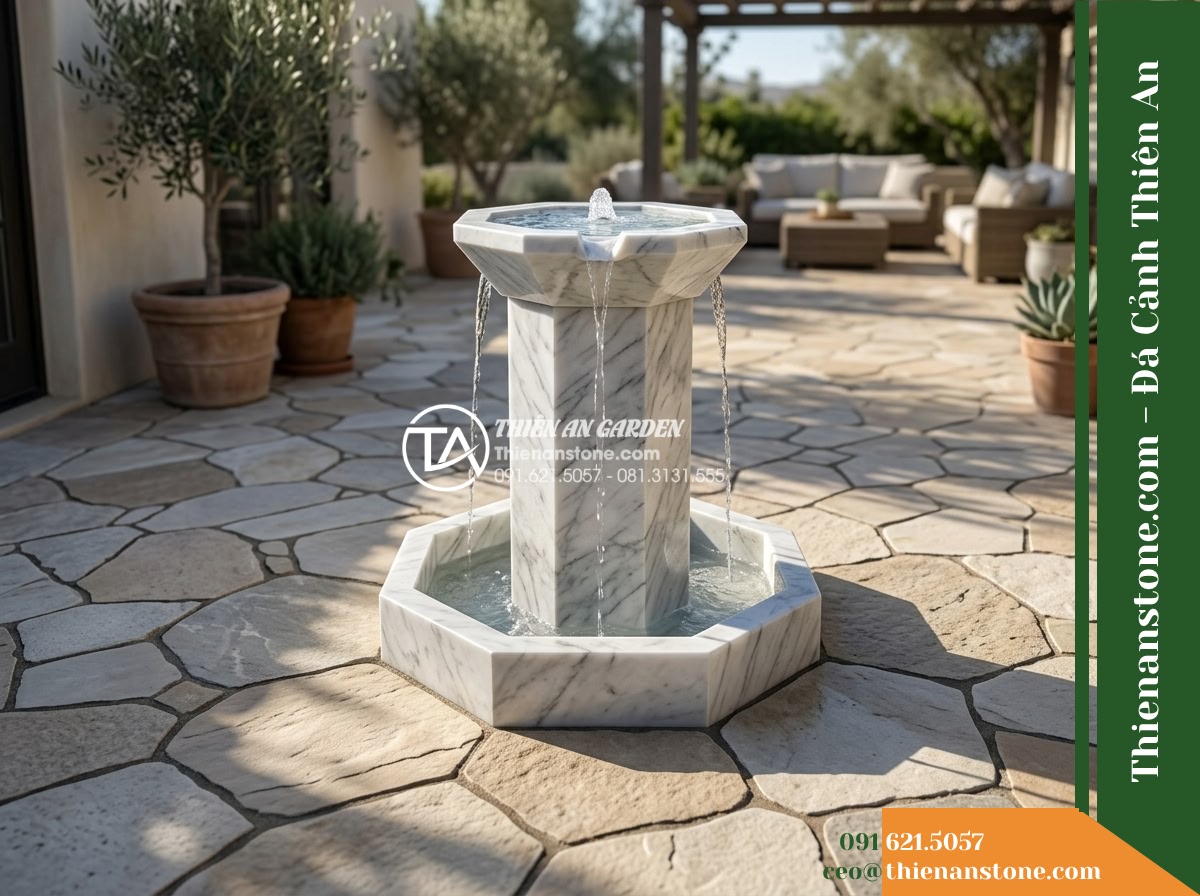 Trụ Phun Lục Giác Đỉnh Bát Phun, D40cm Cao 1m - Hình 10 Trụ Phun Lục Giác Đỉnh Bát Phun, D40cm Cao 1m - Alternative perspective of the stone water feature integrated into an outdoor li